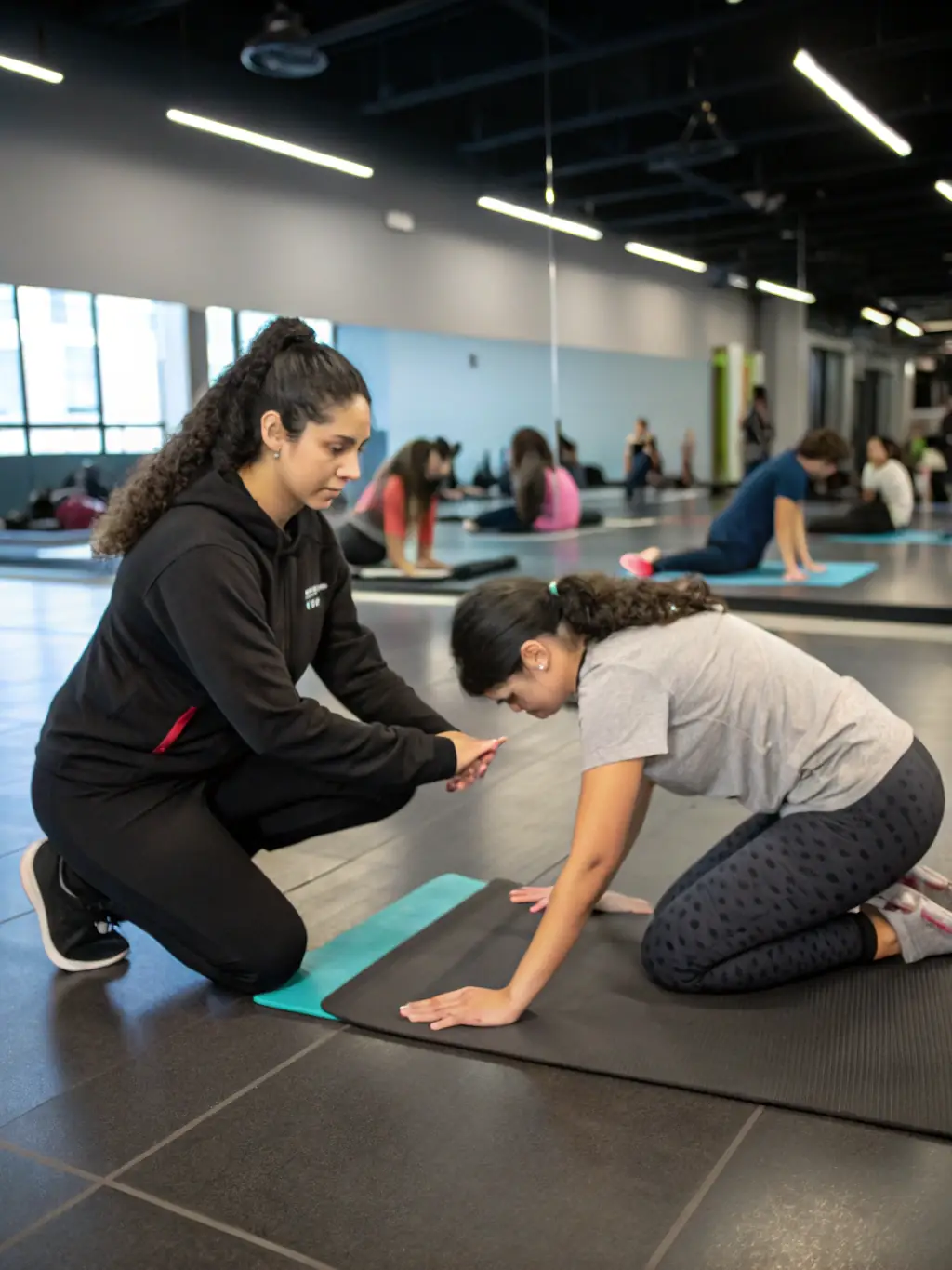 A dedicated student practicing teaching techniques during an instructor training workshop, receiving personalized guidance from a senior instructor.